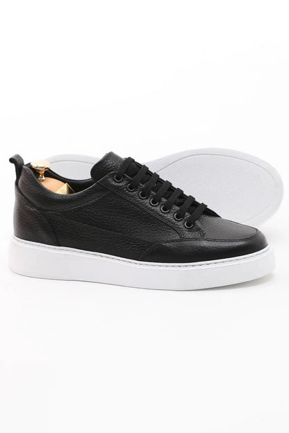 Onyx Luxe Black Leather Sneaker - Elegant Men's Footwear – side profile of one shoe, showcasing premium black floater leather and a contrasting white sole.