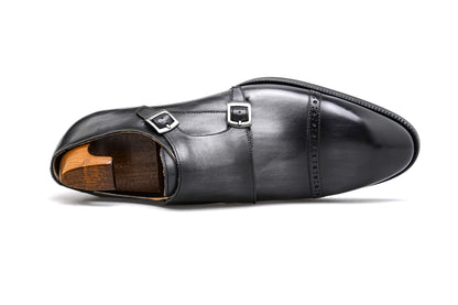 Polished Black Double Monk Strap Leather Shoe – top-down view with shoe tree, emphasizing the double buckle closure and slightly elongated almond toe.