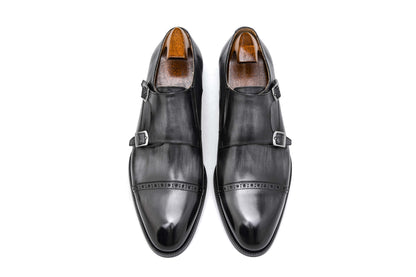 Polished Black Double Monk Strap Leather Shoes – pair with shoe trees, top-down view, showcasing high-gloss full-grain leather and cap-toe broguing.