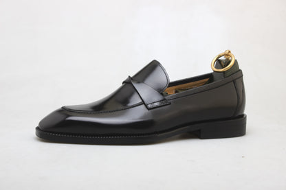 Polished Black Leather Slip-On Loafer for Formal & Semi-Formal Wear – side profile with a shoe tree and unique heel mold holder, showcasing premium black leather and a polished finish.