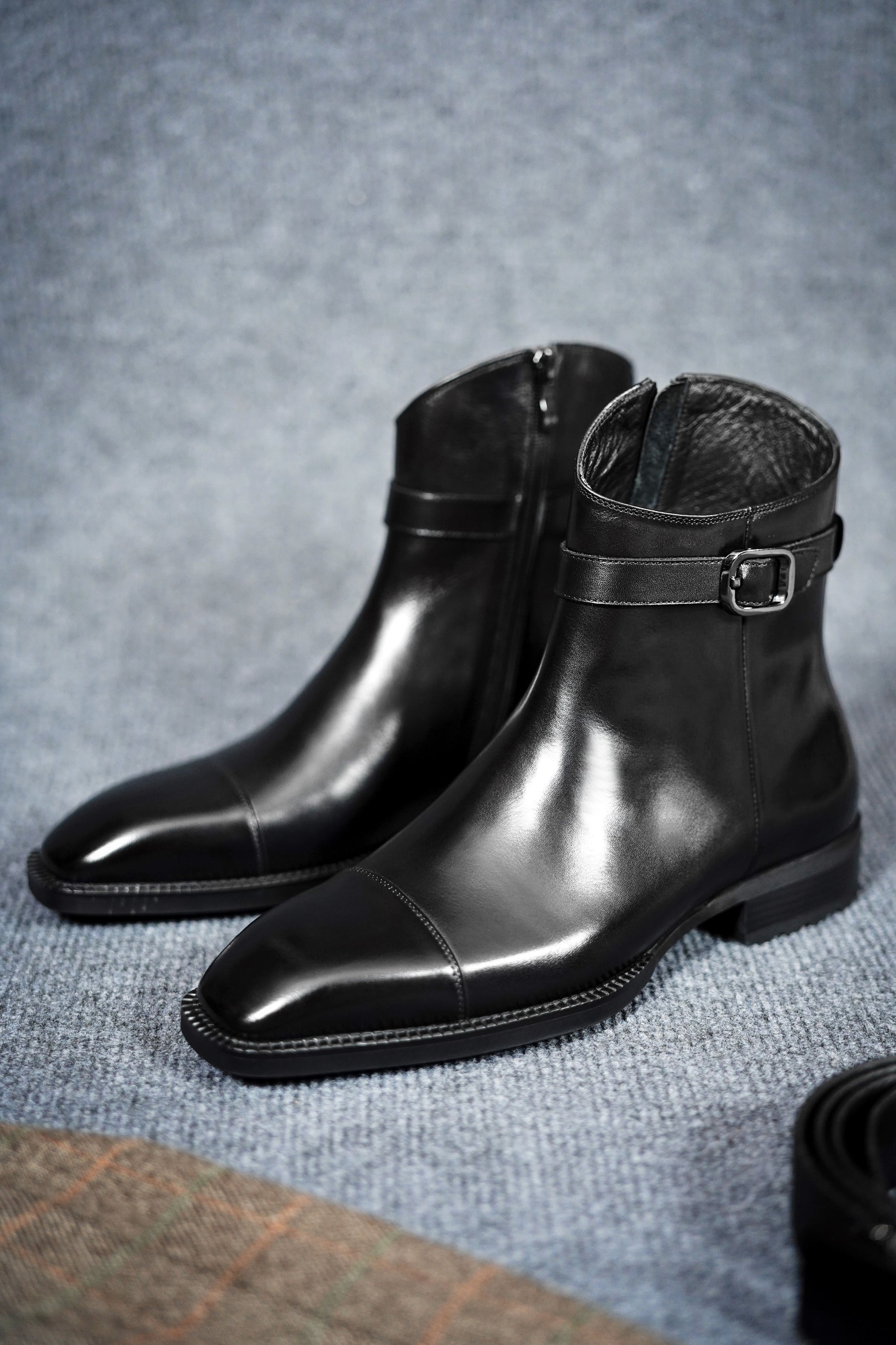 Premium Black Leather Zip-Up Ankle Boots for Formal Wear – a close-up angle of the pair of black leather boots, emphasizing the polish and craftsmanship.

