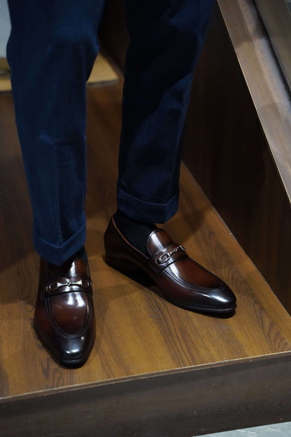 Men's brown leather loafers with metal accents