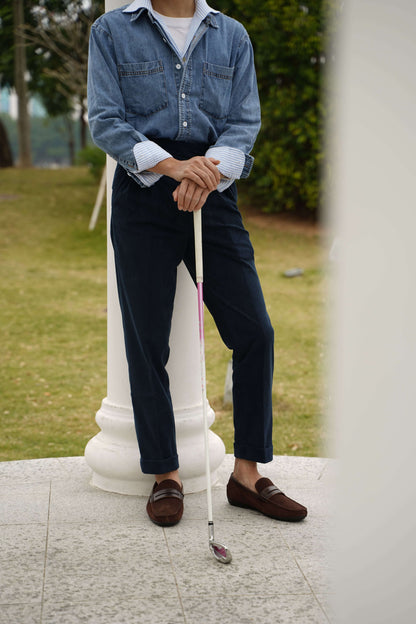 Refined Brown Suede Driving Loafers – worn by a man in a denim shirt and navy trousers, holding a golf club, showcasing a classic and sophisticated look.
