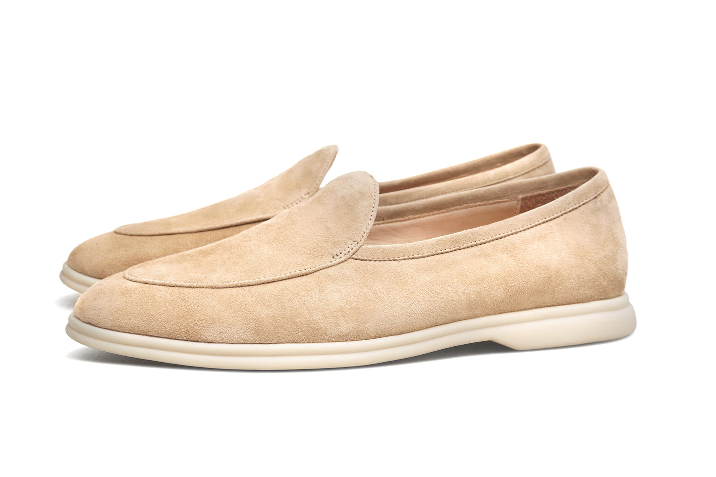 Pair of desert-sand suede Venetian loafers on white background, front view