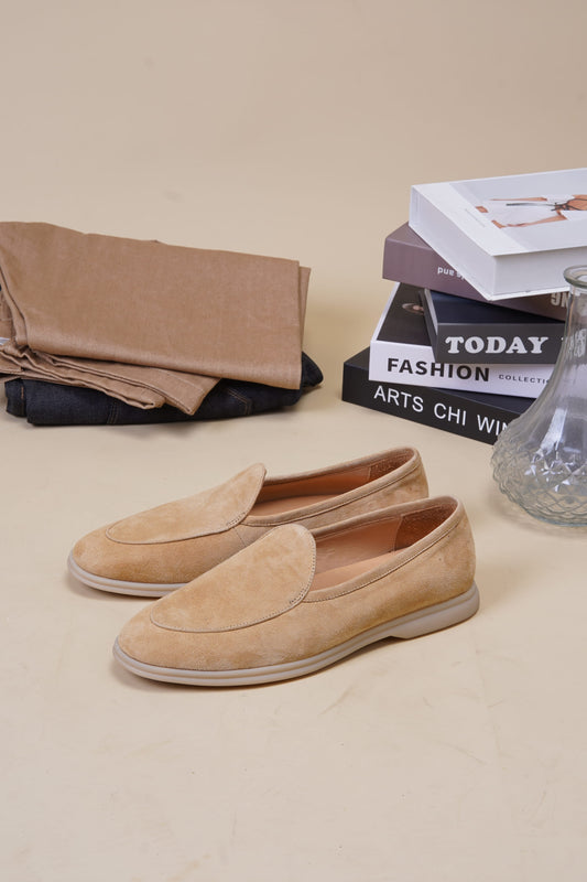 Capri desert-sand suede Venetian loafers styled with linen and books, angled pair view