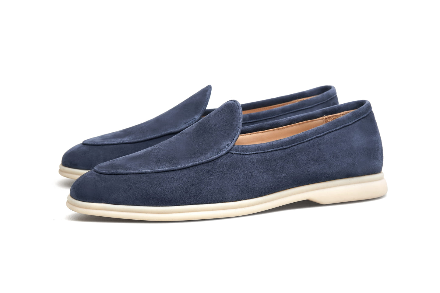 Pair of navy blue suede Venetian loafers on white background, front view