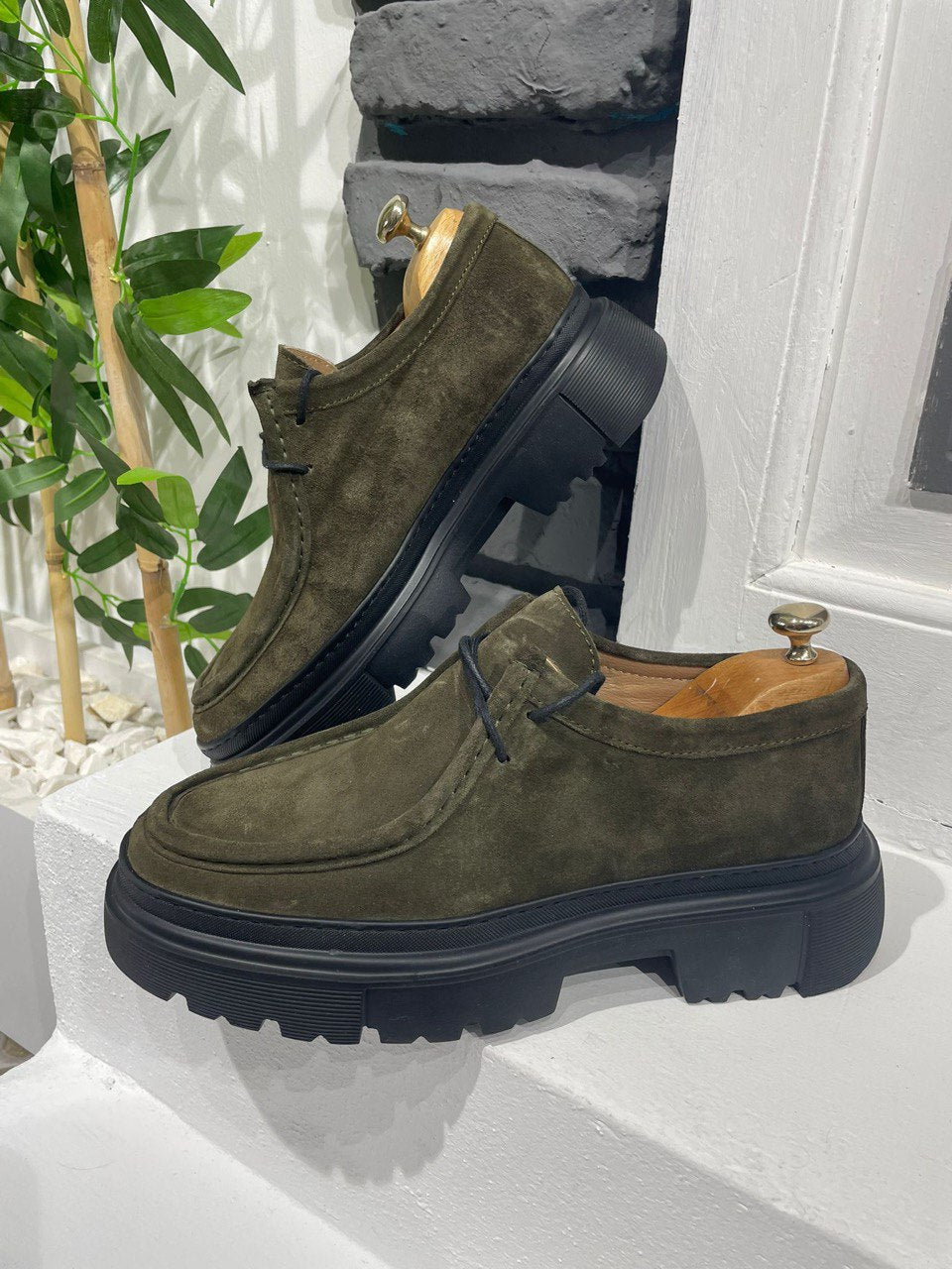 Khaki Suede Lace-Up Chunky Shoes – rugged design on a white ledge with brick wall, ideal for traction and support.