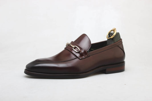 Sophisticated Brown Leather Bit Loafer For Men – side view on white background with a shoe tree, highlighting premium leather, polished finish, and distinctive metal buckle.