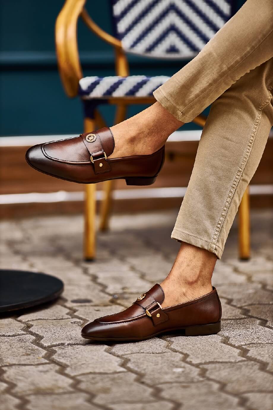 Sophisticated Brown Leather Penny Loafers for Business & Casual Wear – worn by a man in tan chinos, with feet on a paved ground, showcasing premium genuine leather and elegant appeal.