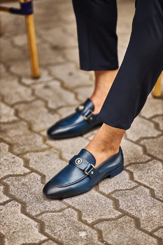 Sophisticated Navy Blue Leather Penny Loafer - Elegance Redefined – close-up on foot, highlighting high-quality leather, a sleek metal buckle, and a navy blue finish.