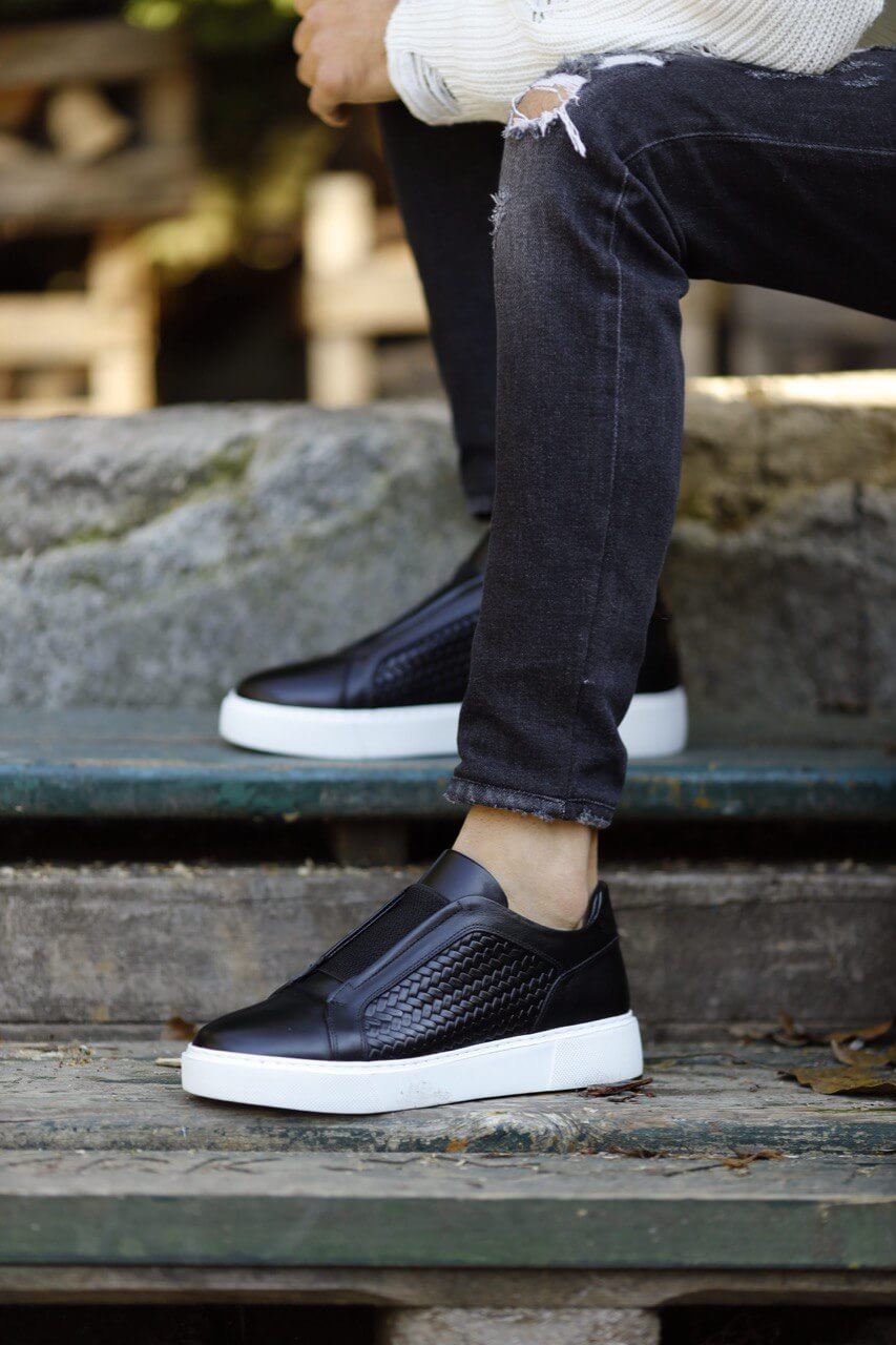 Special Design Black Straw Detail Leather Sneakers – worn by a man in distressed black jeans, sitting on stairs, highlighting a unique straw detail and comfortable fit.