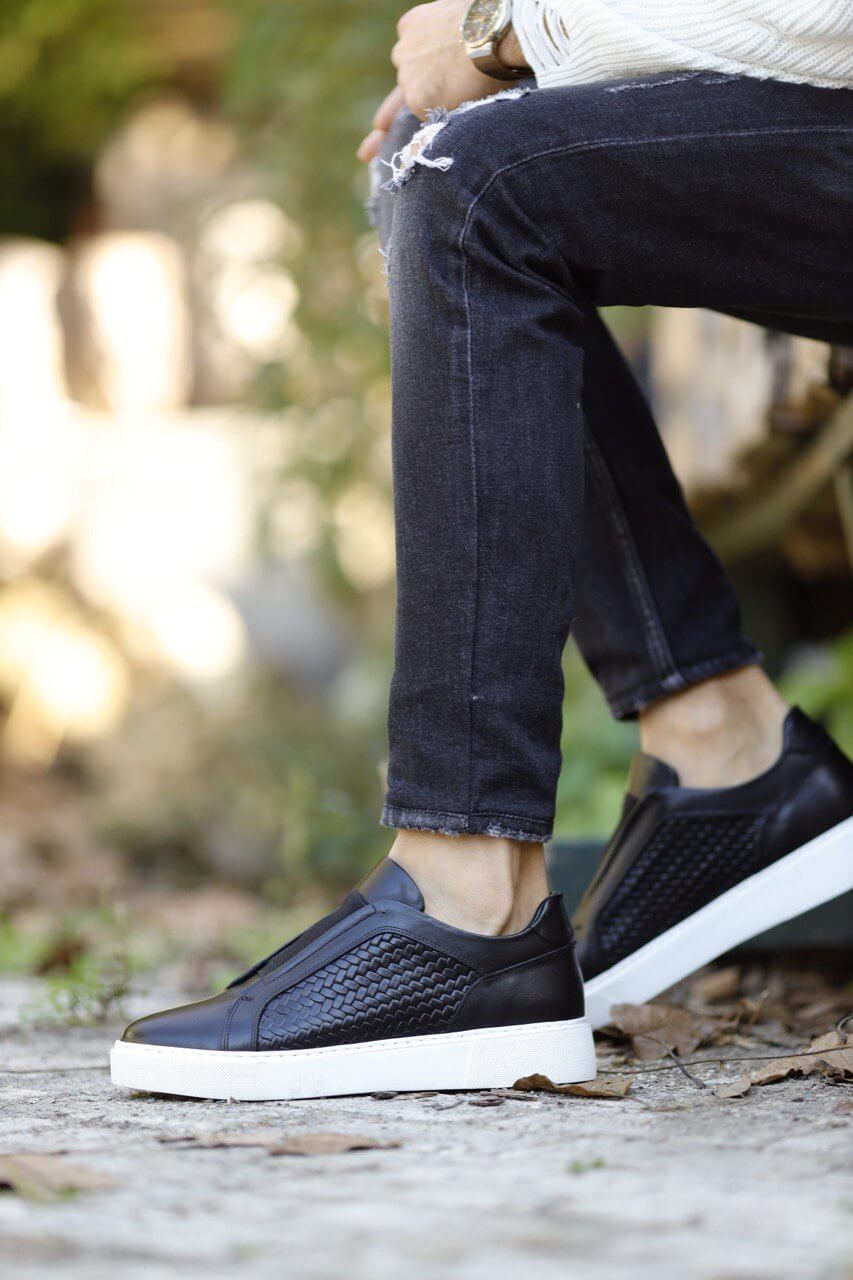 Special Design Black Straw Detail Leather Sneakers – worn by a man in distressed black jeans, on wooden stairs, emphasizing a unique straw detail and cushioned insole.