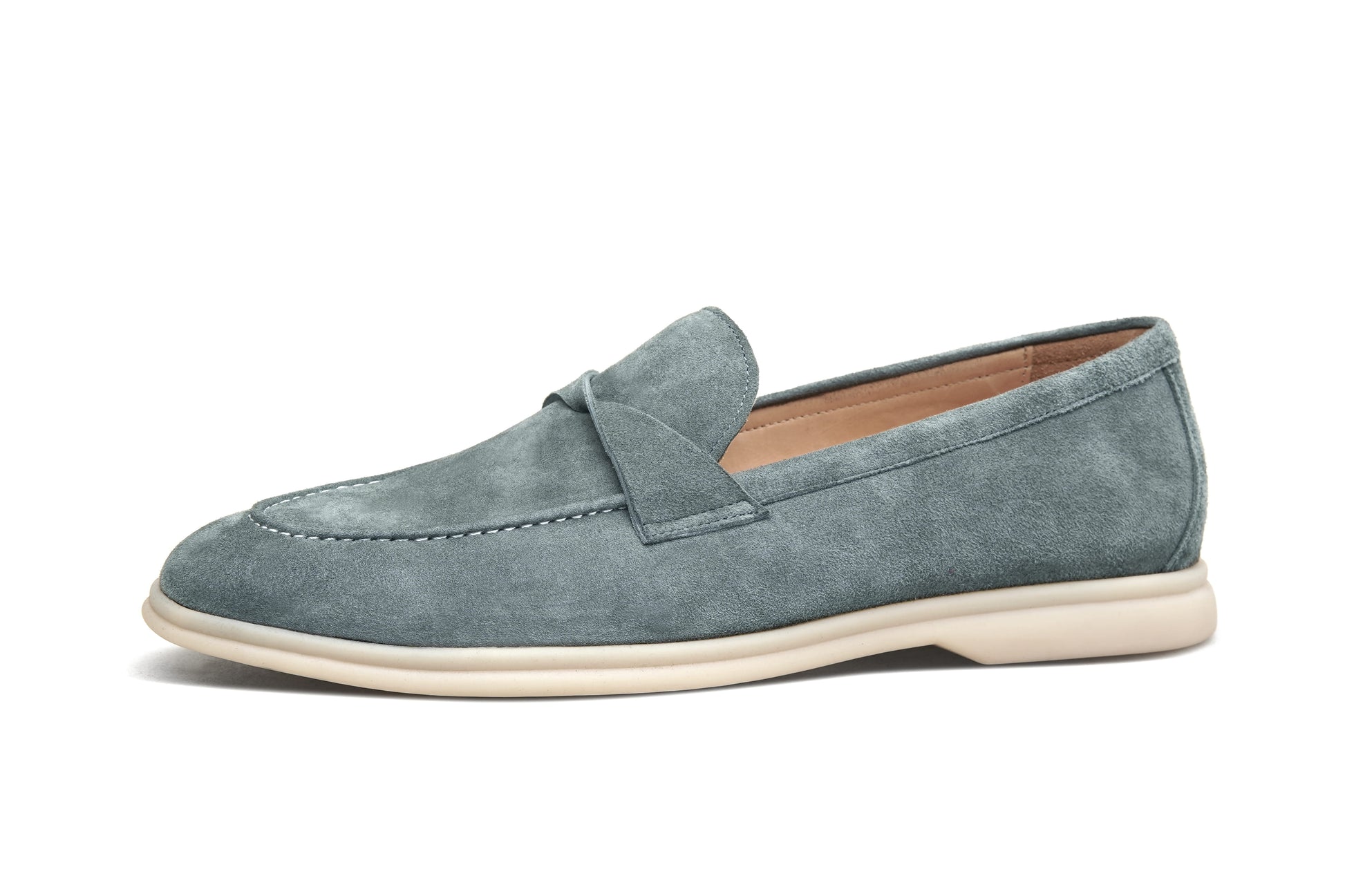Single green suede twist-strap loafer on white background, side profile