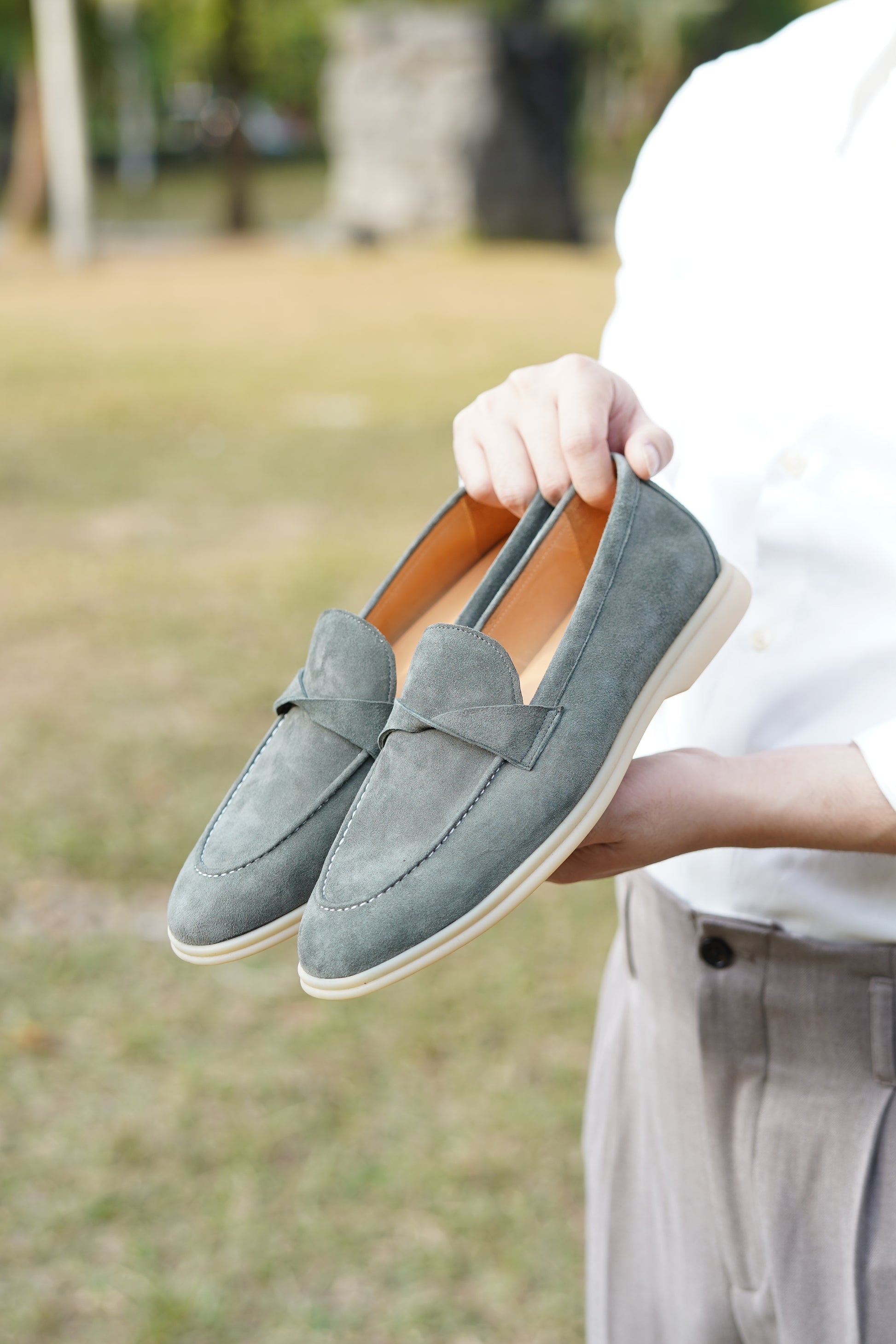Close-up of green suede crossover twist-strap loafer vamp detail
