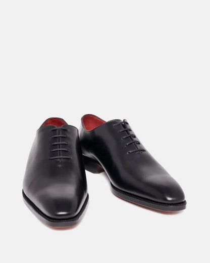 The Nero Noir Polished Black Wholecut Oxford– front angled view showing minimalist design, closed lacing, and red leather interior lining.