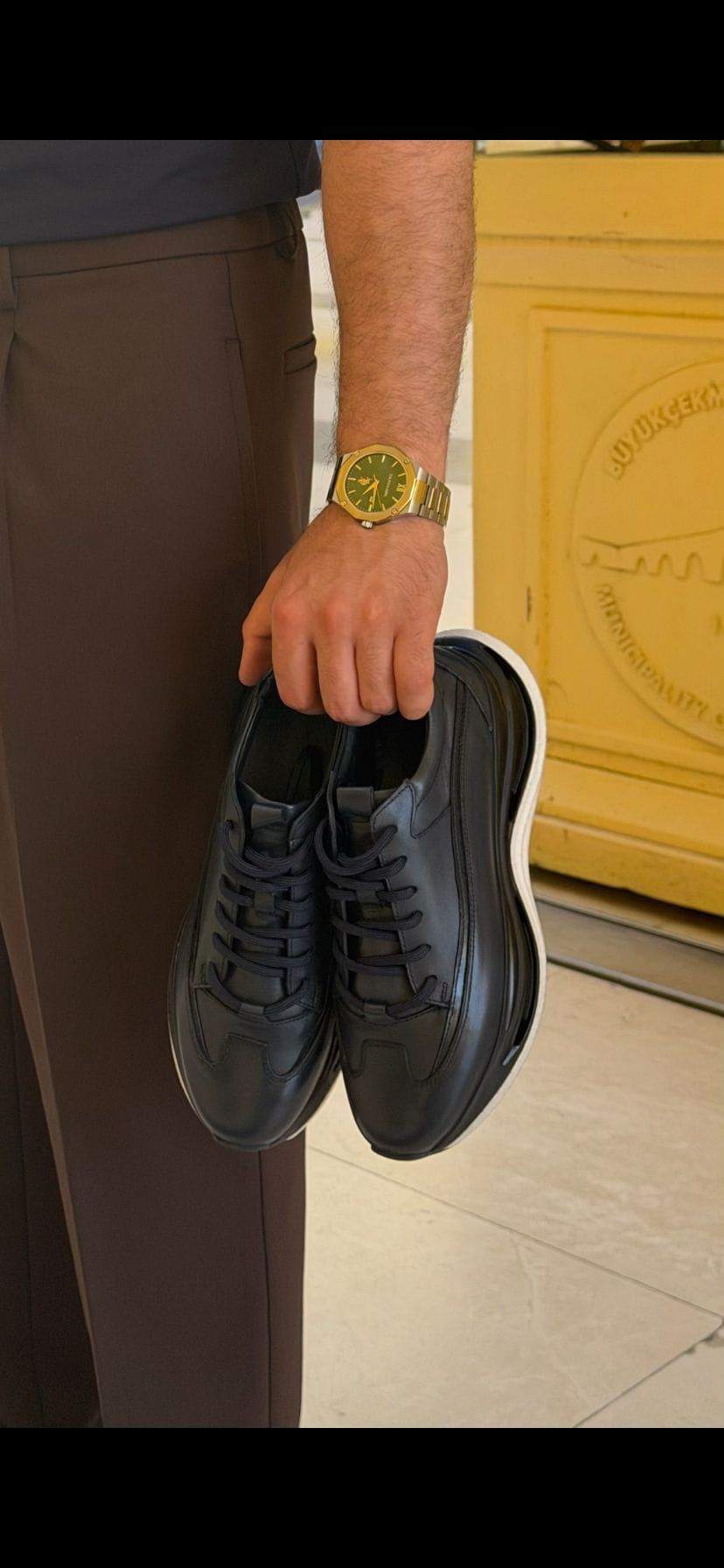 Close-up of Torino black leather runner sneaker highlighting the lace-up design and sculpted oversized sole.