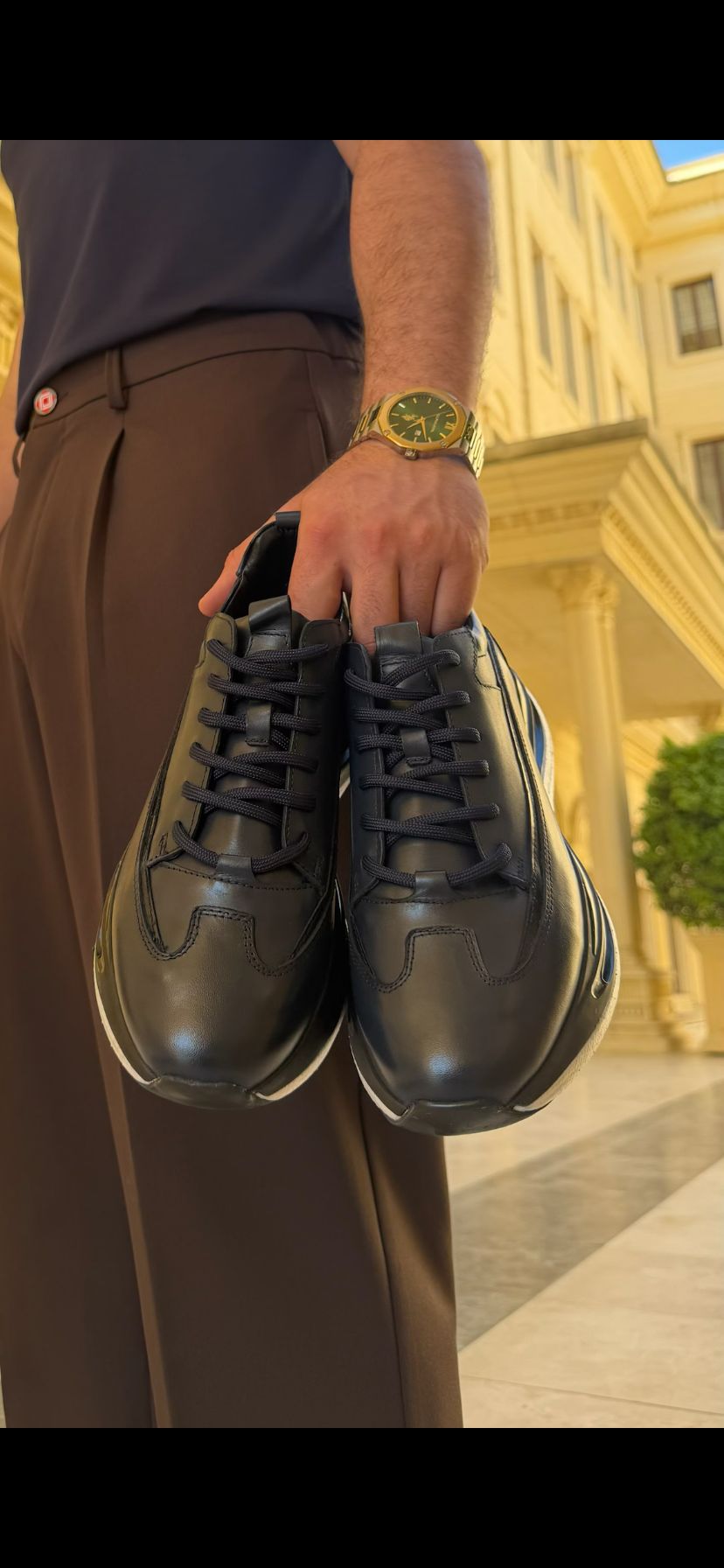 Angled front view of Torino black leather runner sneaker with smooth leather upper and contemporary profile.