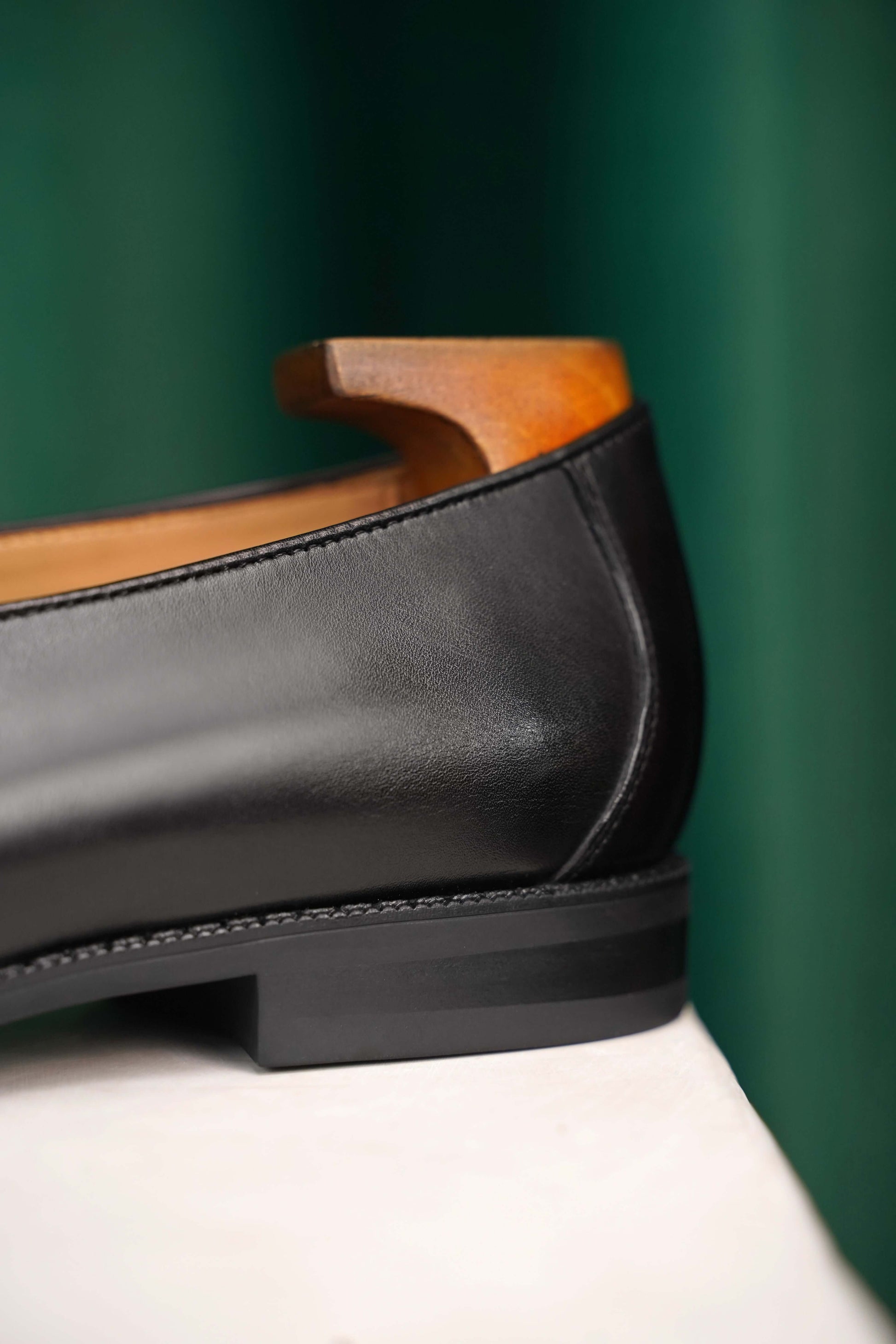 Velvet Crest Black Leather Suede Loafer – close-up of the heel, showing the supple top-grain cowhide and leather lining for quiet confidence.