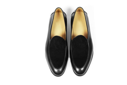 Velvet Crest Black Leather Suede Loafers – pair on a white background, top-down view, emphasizing the contrast in textures for modern simplicity.