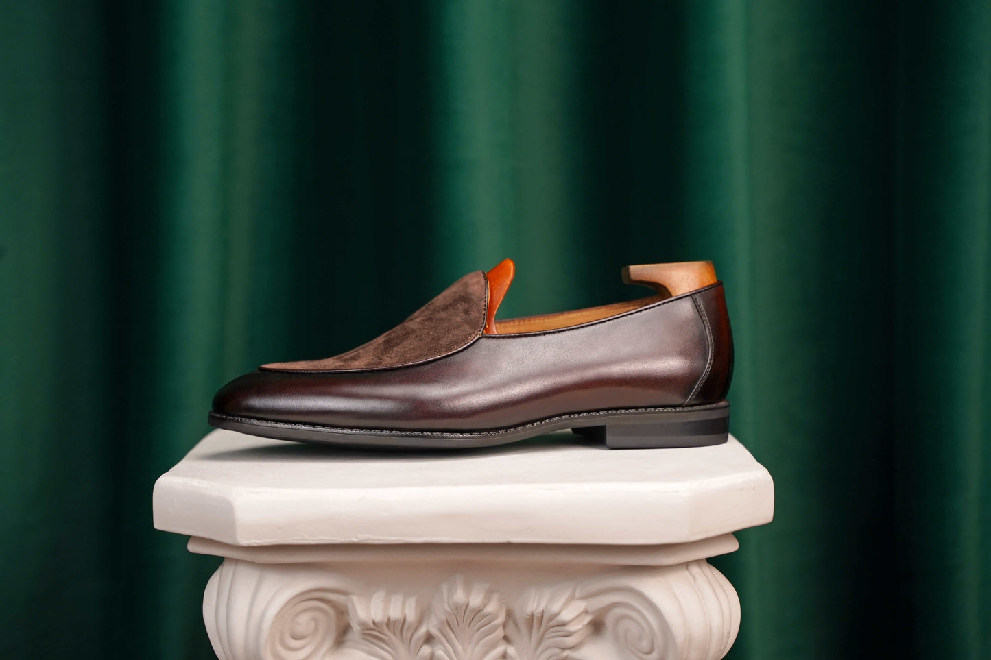 Velvet Crest Brown Leather Suede Loafers – side view with shoe tree on a classical pedestal, highlighting the rich brown leather and suede vamp.