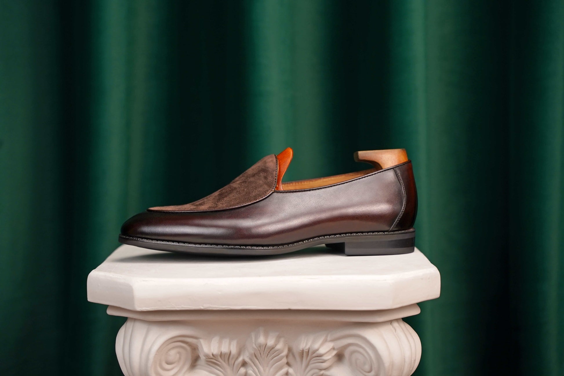 Velvet Crest Brown Leather Suede Loafers – side view with shoe tree on a classical pedestal, highlighting the rich brown leather and suede vamp.