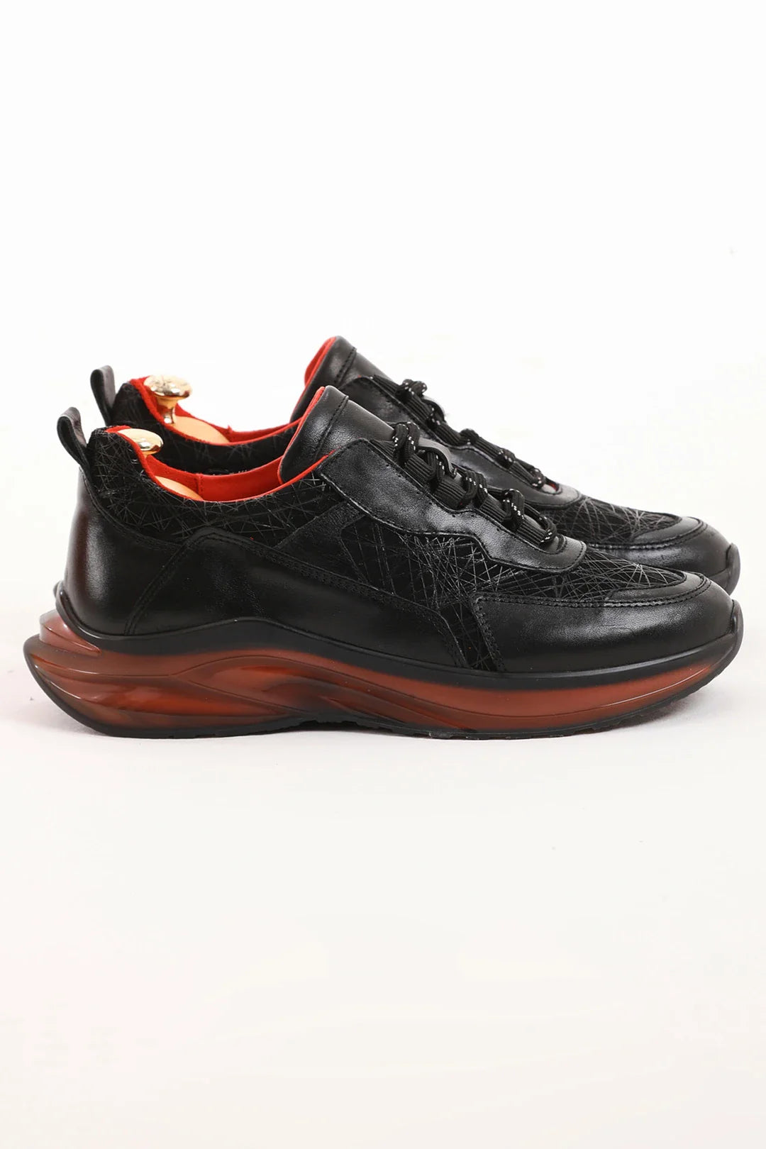 Midnight Raven Luxe Sneaker with premium black leather and red sole accents for men