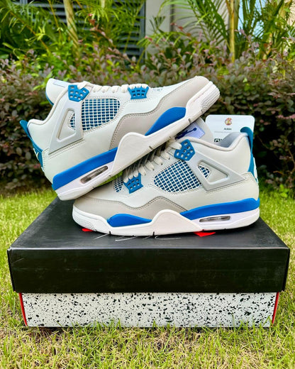 A pair of white Air Jordan 4 sneakers with Military Blue and neutral grey accents.