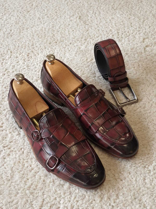 Claret Double Monk Strap Leather Loafers – top-down view of pair with shoe trees and matching belt, highlighting premium red crocodile leather.