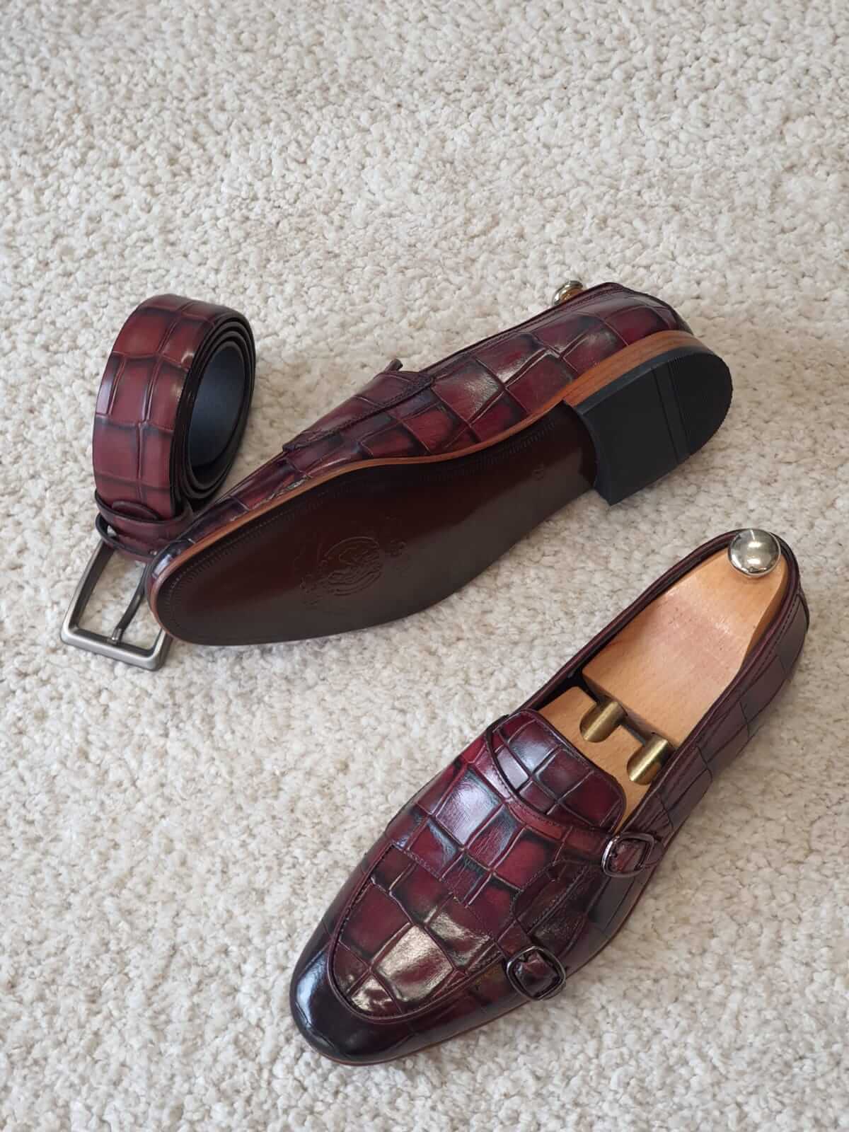 Claret Double Monk Strap Leather Loafers – top-down view of pair with shoe trees and matching belt, highlighting the rich claret hue and formal style.