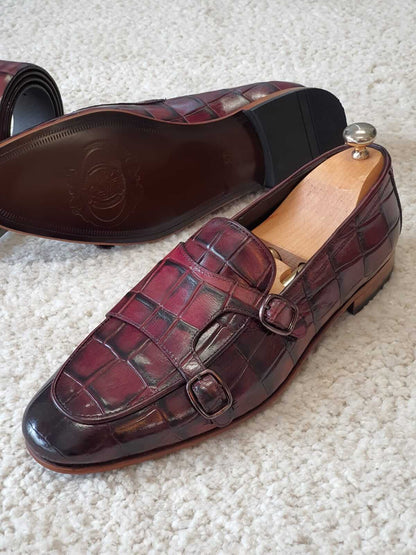 Claret Double Monk Strap Leather Loafer – side view on white rug with shoe tree, emphasizing luxurious red crocodile-embossed leather and bold craftsmanship.