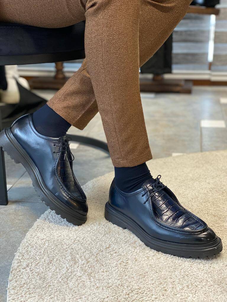 Dark Blue Crocodile Leather Derby Shoes – worn by a man in brown trousers, standing on a white rug, showcasing the lasting style and comfortable fit.