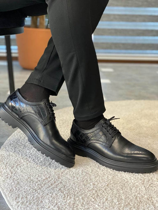 Handcrafted Black Leather Derby Shoes – comfortable fit in polished leather, worn by a man in black trousers, subtly showcasing classic and modern craftsmanship.
