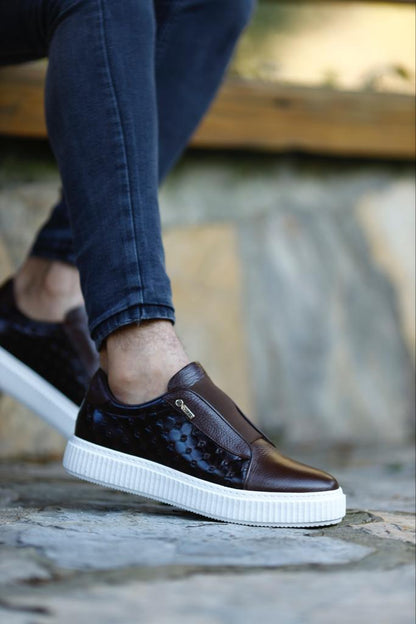 Handcrafted Vortex Brown Float Leather Slip-Ons – worn by a man with one foot elevated, showcasing a blend of traditional craftsmanship and modern innovation.