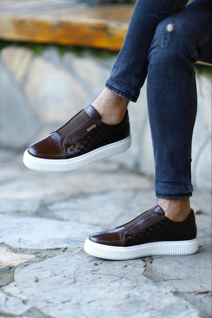 Handcrafted Vortex Brown Float Leather Slip-Ons – worn by a man with one foot elevated, showcasing a blend of traditional craftsmanship and modern innovation.