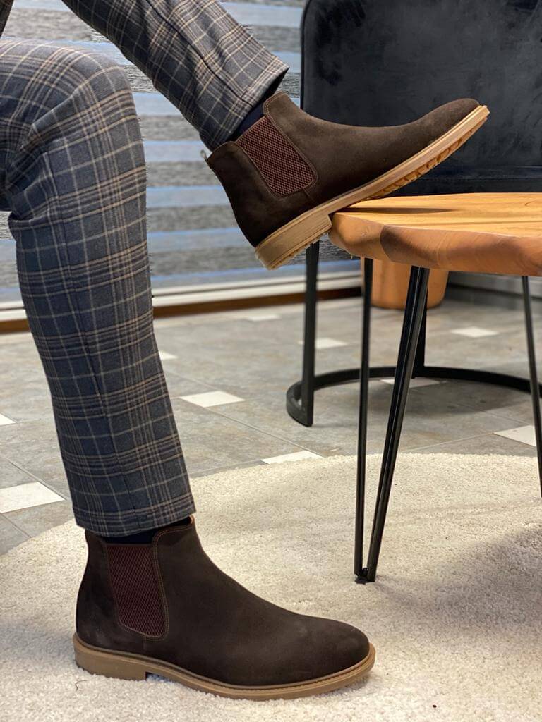 Handmade Brown Suede Leather Chelsea Boots – a man posing with one foot on a table, showcasing the durable EVA sole and the boot's profile.