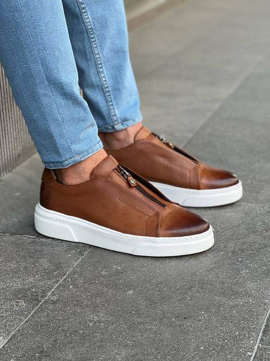 HolloShoe Brown Mid-Top Zipper Slip-Ons for Men – worn by a man in blue jeans, leaning against a wall, highlighting a modern touch and a versatile look.