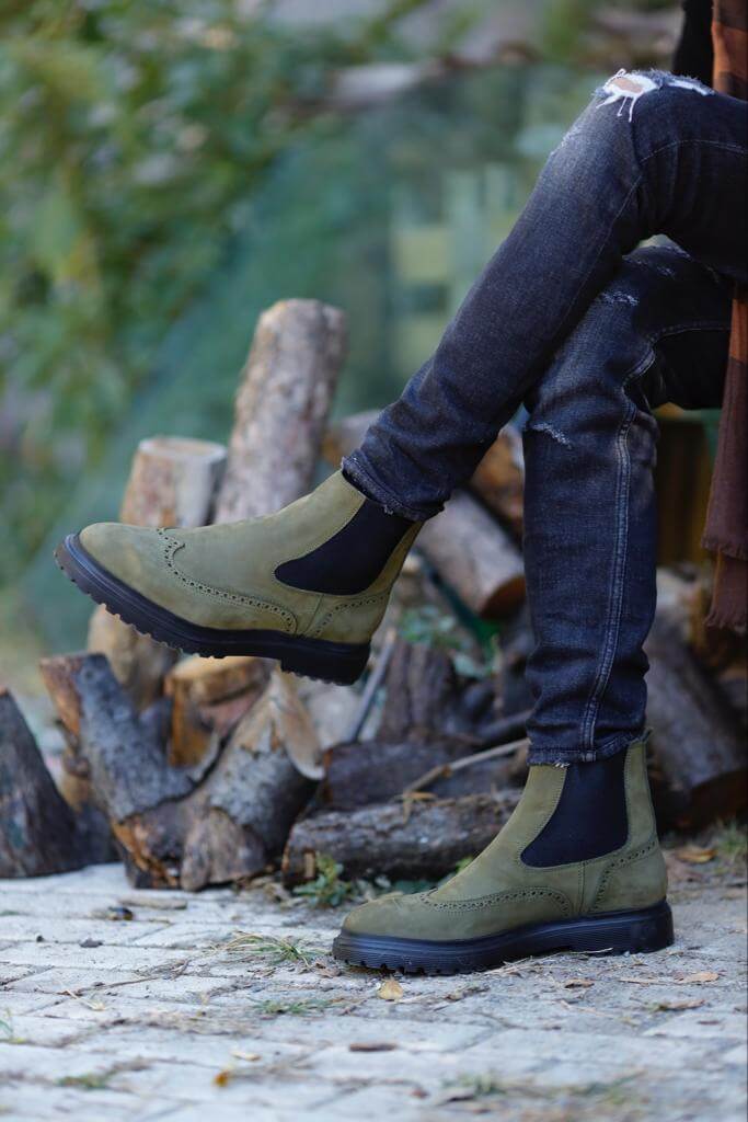 HolloShoe Khaki Nubuck Wingtip Chelsea Boots for All-Day Comfort – a side view of a man sitting with the boots on, focusing on the quality of the nubuck and the casual style.