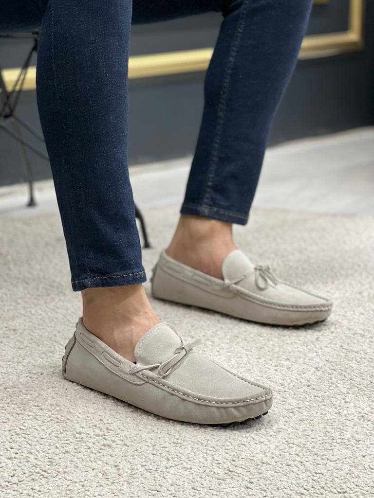 Premium Oakmond Gray Suede Driving Loafers – close-up of man's feet in gray suede loafers, showing the front view and moccasin stitching.