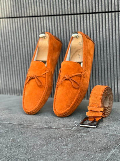 Premium Oakmond Orange Suede Driving Loafers – pair displayed on a floor, with a matching belt, showcasing a luxurious touch and comfortable fit.